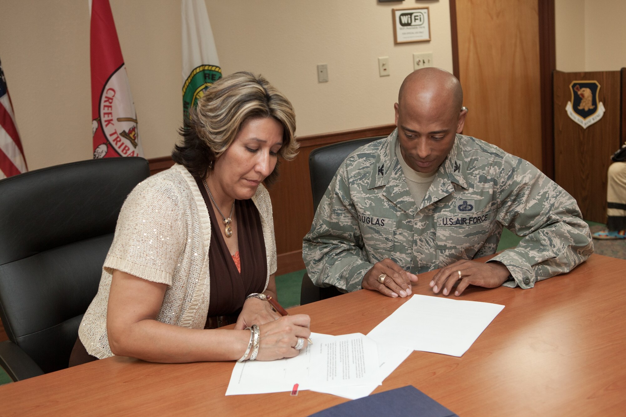 From left, Celesta Johnson, Secretary of Thlopthlocco Tribal Town, and Col. Antonio Douglas, 96th Test Wing Support vice commander, signed a memorandum of understanding during a ceremony in 2012. The memorandum brought together members of two Oklahoma-based tribes and Eglin AFB leadership. (U.S. Air Force photo)