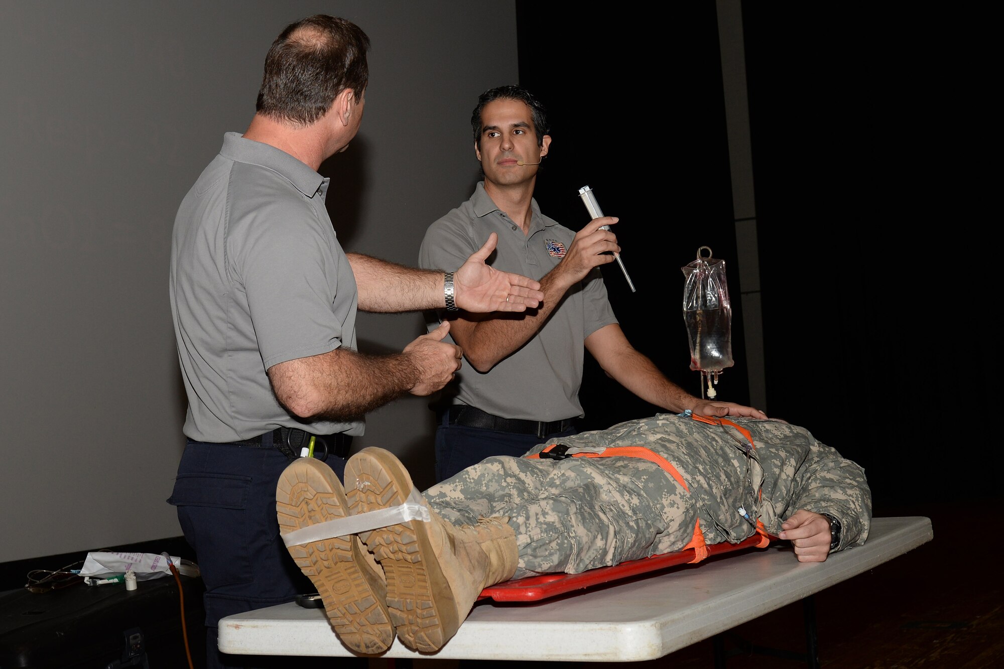 Ralph Jimenez and Oscar Duran, Miami-Dade County, Fla., Fire-Rescue paramedics, simulated steps paramedics may use to save the life of a vehicle accident victim during the Stay Alive From Education Street Smart Program at Fort Eustis, Va., Nov. 4, 2014.  Street Smart presenters travel to multiple military bases nationwide to educate Service members about the perils of drunk and distracted driving. (U.S. Air Force photo by Staff Sgt. Teresa J. Cleveland/Released)