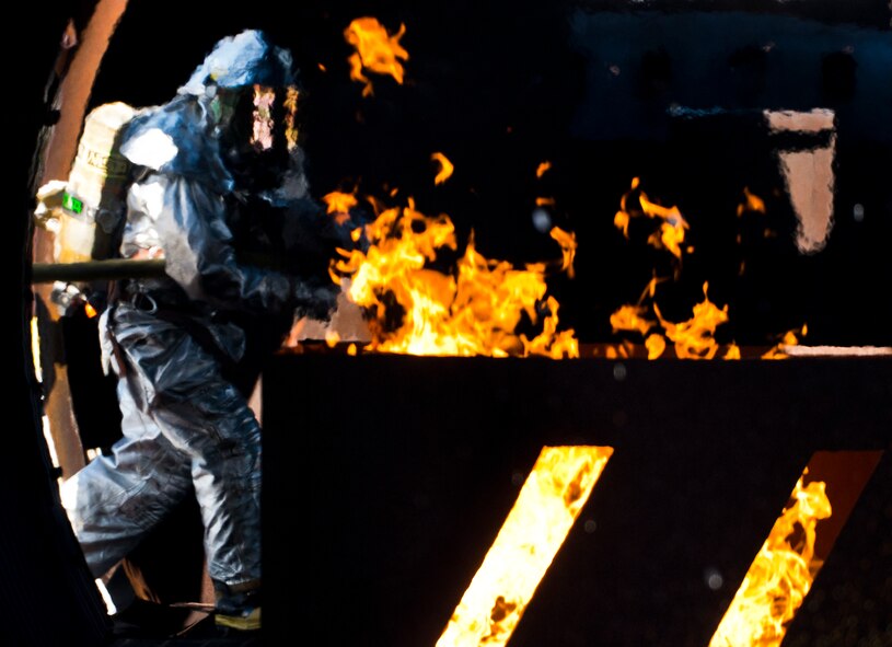 A 919th Special Operations Wing firefighter enters the aircraft during a training exercise at Eglin Air Force Base, Fla., Oct. 31.  The reserve firefighters from Duke Field used Eglin’s aircraft fire pit to meet their annual training requirements.  (U.S. Air Force photo/Tech. Sgt. Sam King)