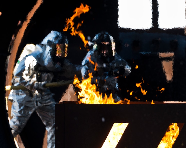 Firefighters from the 919th Special Operations Wing enter the aircraft during a training exercise at Eglin Air Force Base, Fla., Oct. 31.  The reserve firefighters from Duke Field used Eglin’s aircraft fire pit to meet their annual training requirements.  (U.S. Air Force photo/Tech. Sgt. Sam King)
