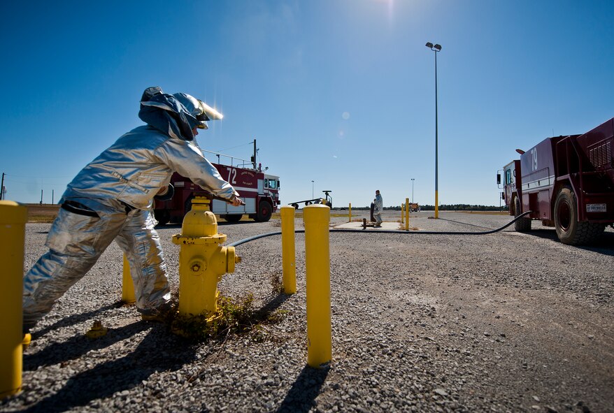 A 919th Special Operations Wing firefighter opens a hydrant valve to refill a fire truck after a training exercise at Eglin Air Force Base, Fla., Oct. 31.  The reserve firefighters from Duke Field used Eglin’s aircraft fire pit to meet their annual training requirements.  (U.S. Air Force photo/Tech. Sgt. Sam King)