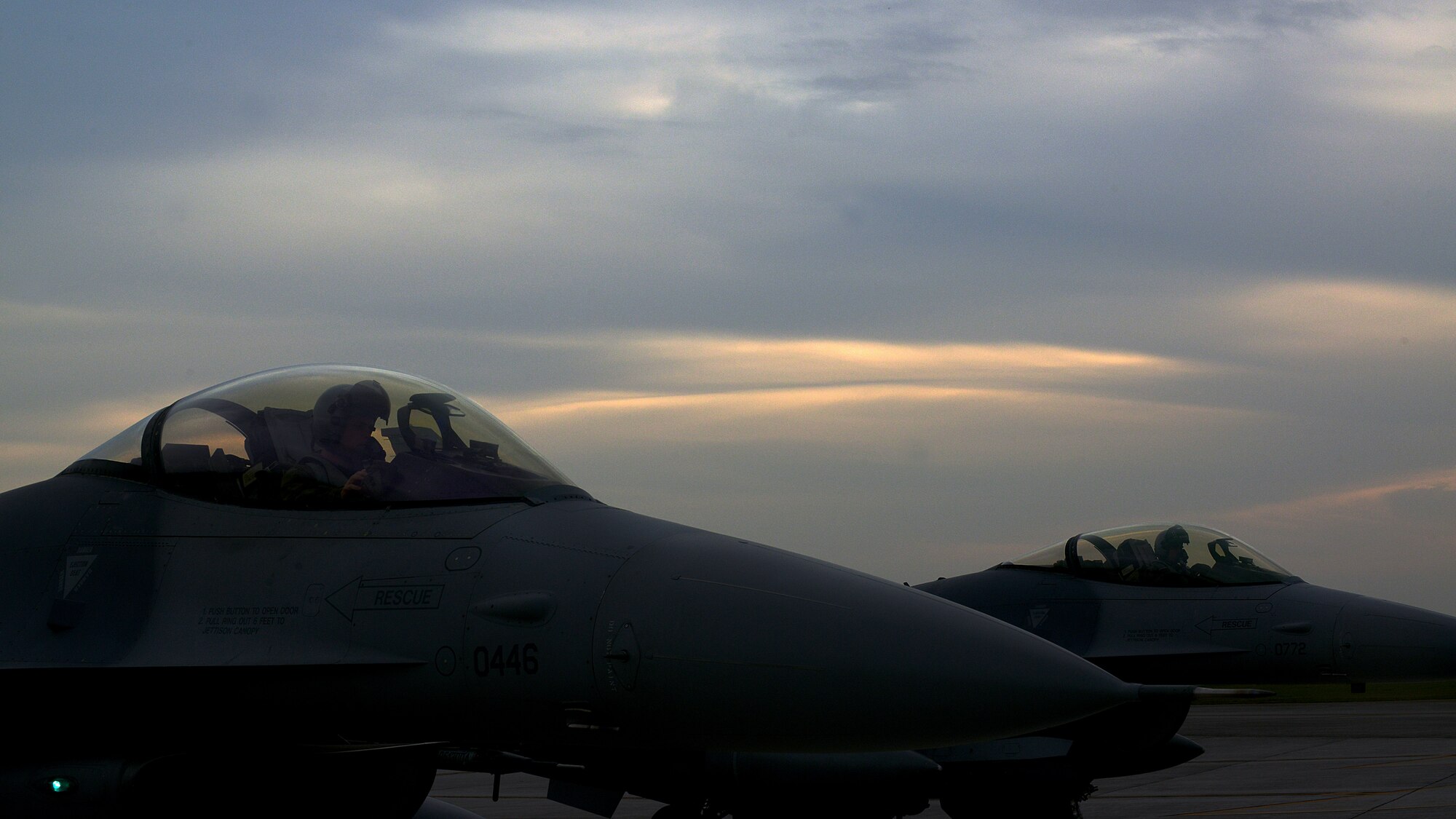 Capt. Matthew Alexander, 555th Fighter Squadron pilot, and Maj. Vincent O’Connor, 31st Fighter Wing commander’s action group, sit on the flightline while being de-armed after a training flight, Oct. 15, 2014, at Aviano Air Base, Italy. Pilots simulate air-to-air and air-to-ground missions so that they’re capable of fulfilling those roles if the Air Force ever requires it. (U.S. Air Force photo/Airman 1st Class Ryan Conroy) 