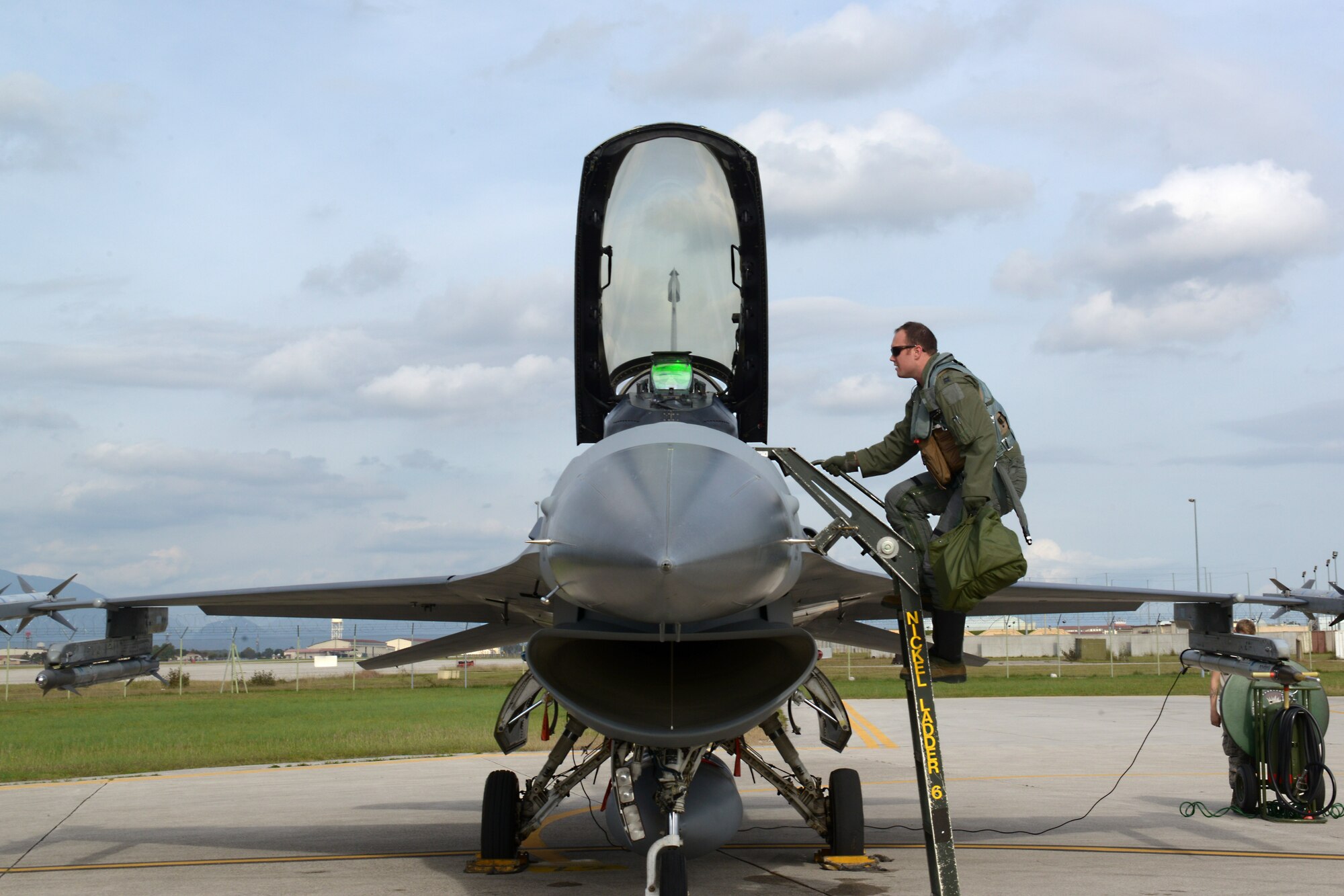Capt. Matthew Alexander, 555th Fighter Squadron pilot, climbs a ladder to an F-16 Fighting Falcon, Oct. 15, 2014, at Aviano Air Base, Italy. Alexander is an U.S. Air Force fighter pilot and his mission is to deter aggression through a rigorous training program. (U.S. Air Force photo/Airman 1st Class Ryan Conroy)
