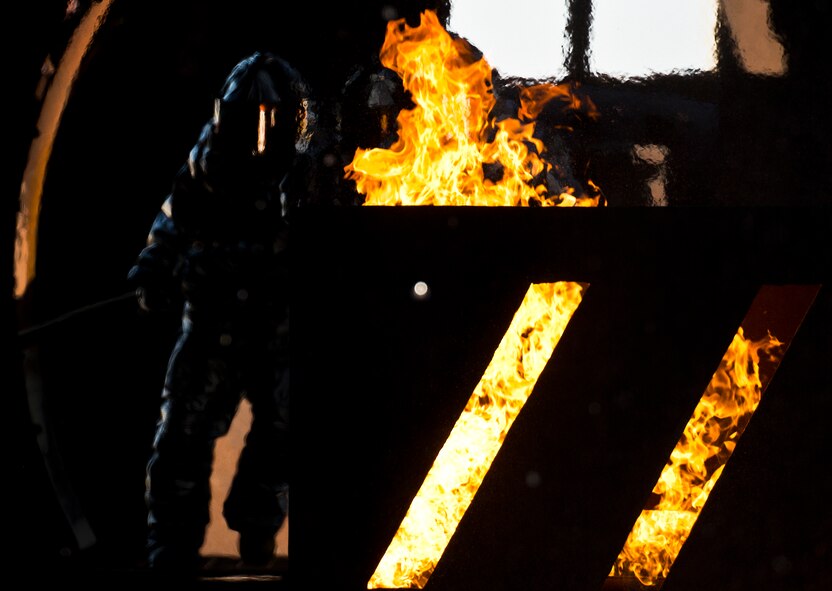 Firefighters from the 919th Special Operations Wing take position in front of the fire during a training exercise at Eglin Air Force Base, Fla., Oct. 31.  The reserve firefighters from Duke Field used Eglin’s aircraft fire pit to meet their annual training requirements.  (U.S. Air Force photo/Tech. Sgt. Sam King)