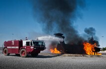 Firefighters from the 919th Special Operations Wing, fire a water cannon at an aircraft fire from their fire truck during a training exercise at Eglin Air Force Base, Fla., Oct. 31.  The reserve firefighters from Duke Field used Eglin’s aircraft fire pit to meet their annual training requirements.  (U.S. Air Force photo/Tech. Sgt. Sam King)