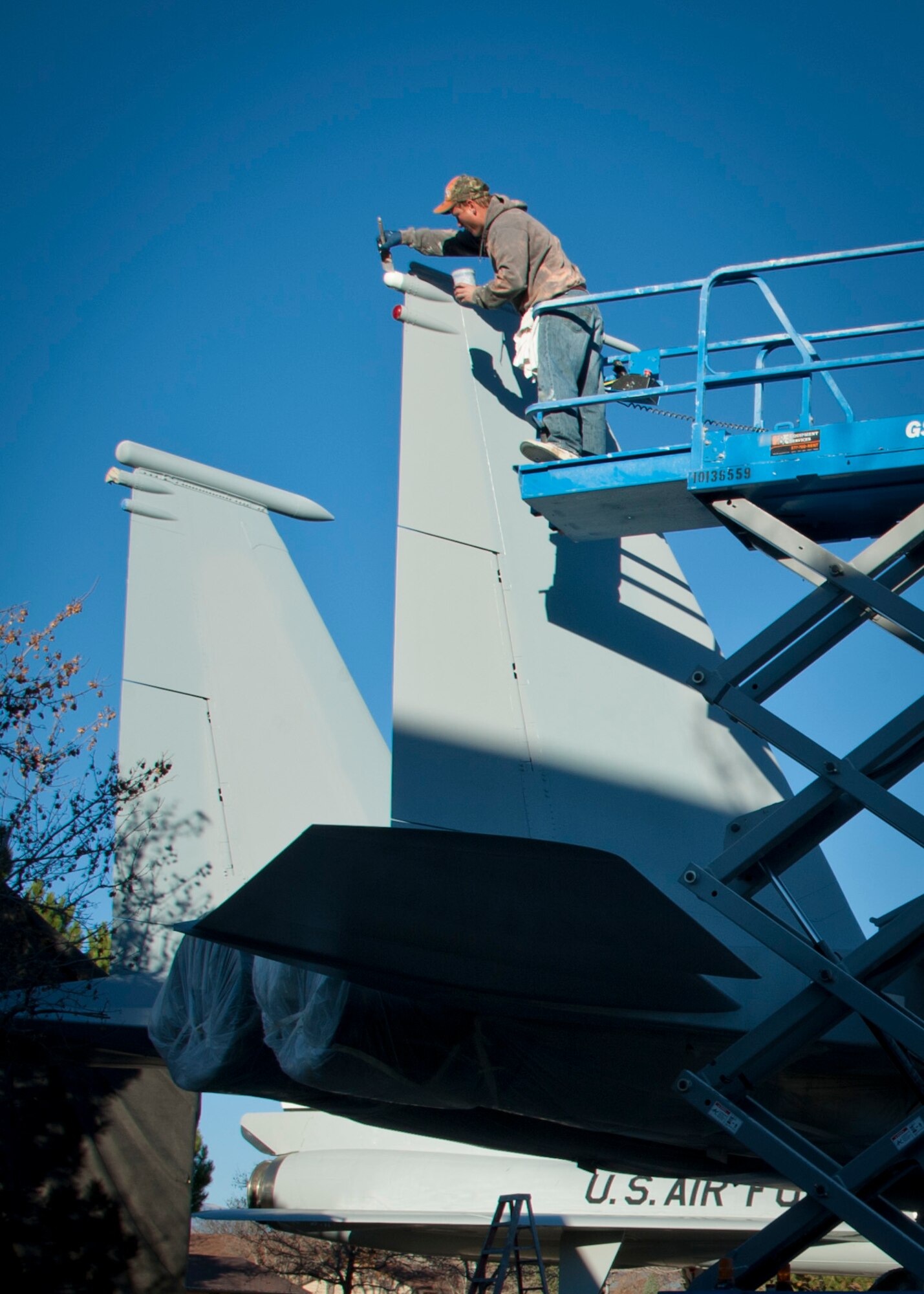 PETERSON AIR FORCE BASE, Colo. – Chris Ransom, a painting contractor, applies paint to the tail light of an F-15 Strike Eagle aircraft at the base museum Oct. 30. Ransom is part of a contracted crew hired to repaint and touch up 10 aircraft maintained by the museum to ensure these artifacts remain accurate representations of these once high-soaring crafts that now reside at Peterson AFB. (U.S. Air Force photo/Staff Sgt. J. Aaron Breeden)