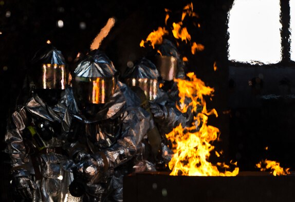 Firefighters from the 919th Special Operations Wing move in to put the fire out during a training exercise at Eglin Air Force Base, Fla., Oct. 31.  The reserve firefighters from Duke Field used Eglin’s aircraft fire pit to meet their annual training requirements.  (U.S. Air Force photo/Tech. Sgt. Sam King)
