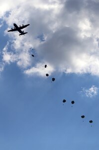 Paratroopers with the Texas Army National Guard 1st Battalion (Airborne), 143rd Infantry Regiment, parachute onto a drop zone Oct. 24, 2014 at Joint Base San Antonio-Camp Bullis. The joint exercise provided relevant training opportunities to service members to train on both individual and collective team skills to help meet mission readiness requirements. (U.S. Air Force photo by Johnny Saldivar)