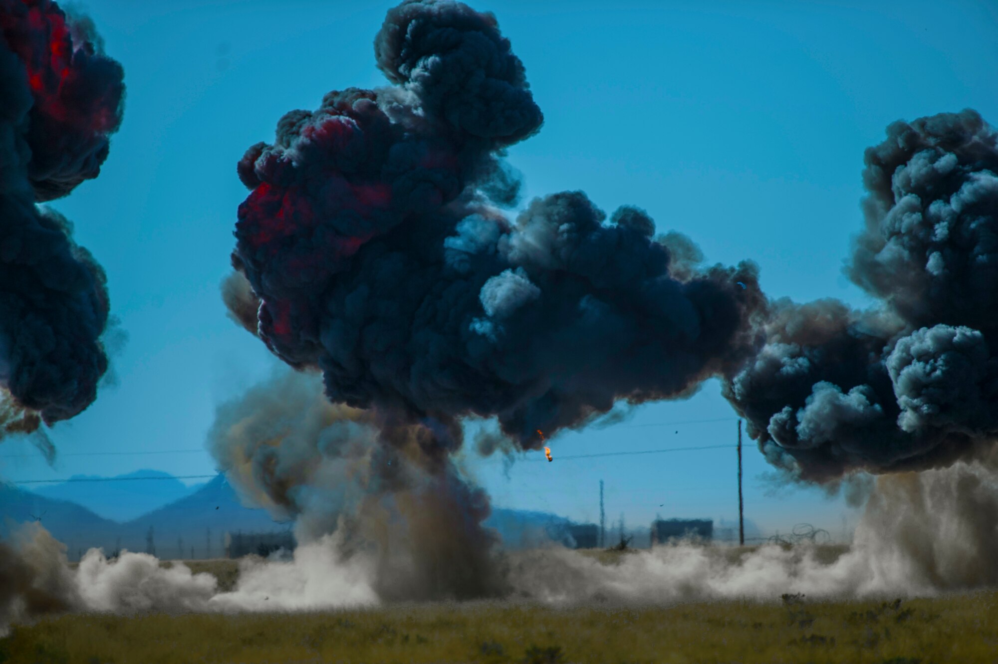 Explosives are detonated during the inaugural blast of a new demolition range located at Holloman Air Force Base, N.M., Oct. 28. The 49th Civil Engineer Squadron Explosive Ordnance Disposal technicians opened a new demolition range on Holloman and detonated 50 pounds of explosives to commemorate it’s activation. EOD technicians handle live explosives on a daily basis, and they use that knowledge to detect, identify, recover and dispose of explosives and ordnance that are unsafe or could pose a threat. (U.S. Air Force photo by Airman 1st Class Aaron Montoya / Released)