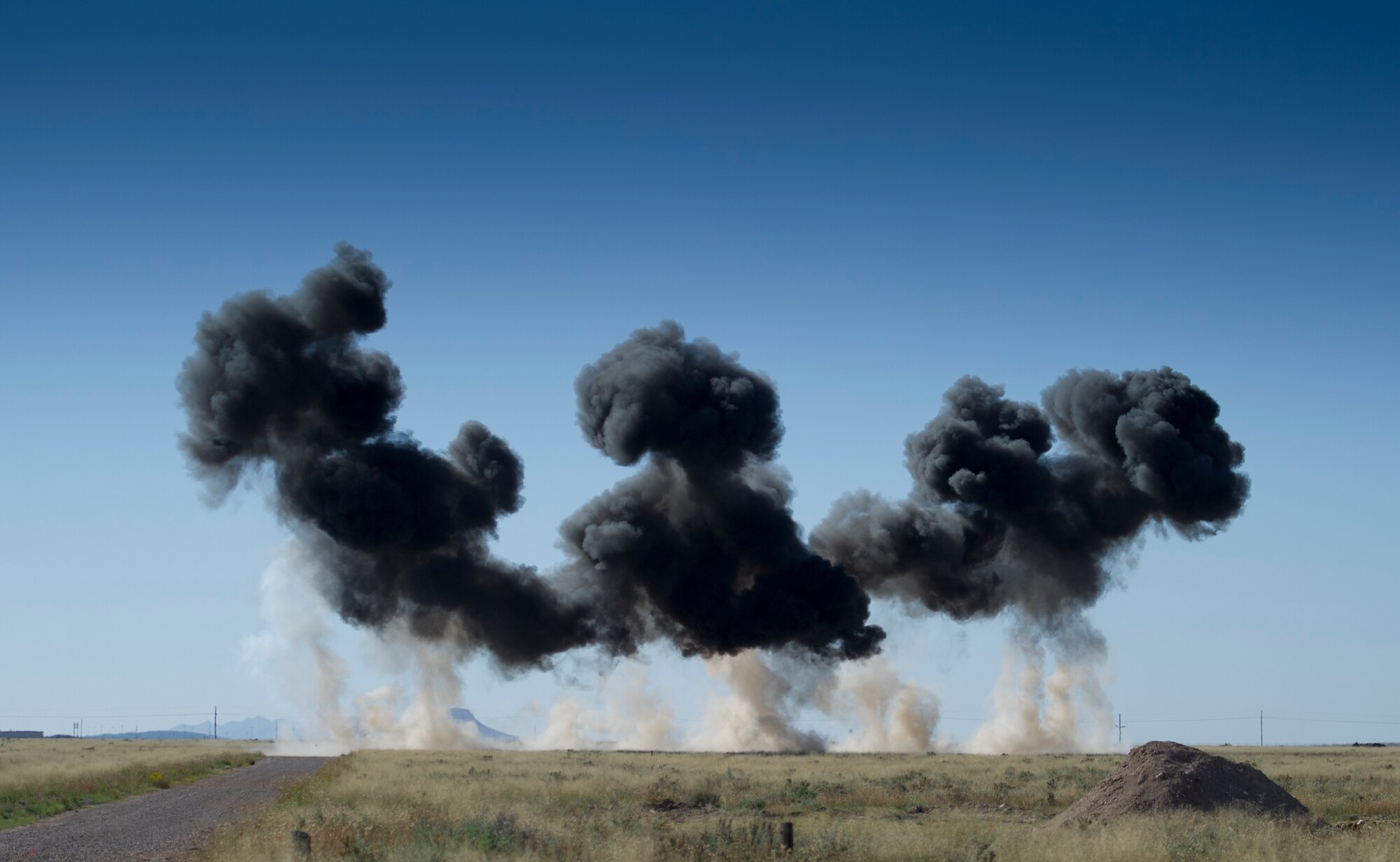 Explosives are detonated during the inaugural blast of a new demolition range located at Holloman Air Force Base, N.M., Oct. 28. The 49th Civil Engineer Squadron Explosive Ordnance Disposal technicians opened a new demolition range on Holloman and detonated 50 pounds of explosives to commemorate it’s activation. EOD technicians handle live explosives on a daily basis, and they use that knowledge to detect, identify, recover and dispose of explosives and ordnance that are unsafe or could pose a threat. (U.S. Air Force photo by Staff Sgt. Stacy Moless / Released)