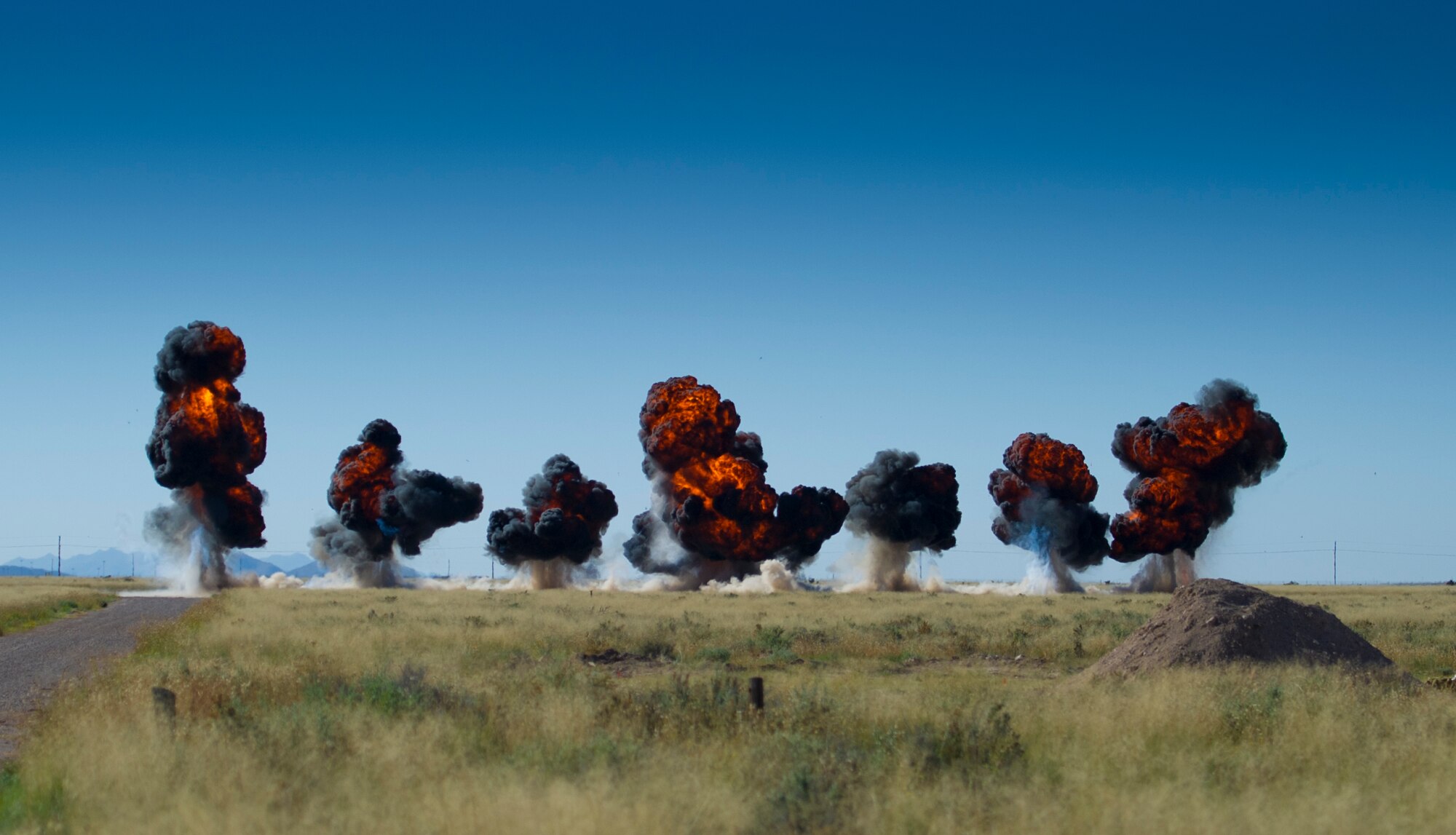 Explosives are detonated during the inaugural blast of a new demolition range located at Holloman Air Force Base, N.M., Oct. 28. The 49th Civil Engineer Squadron Explosive Ordnance Disposal technicians opened a new demolition range on Holloman and detonated 50 pounds of explosives to commemorate it’s activation. EOD technicians handle live explosives on a daily basis, and they use that knowledge to detect, identify, recover and dispose of explosives and ordnance that are unsafe or could pose a threat. (U.S. Air Force photo by Staff Sgt. Stacy Moless / Released)