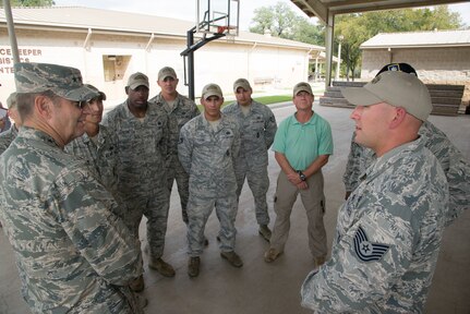 Gen. Robin Rand, commander of Air Education and Training Command, visits with security force academy instructors during his visit to the 343rd Training Squadron Oct. 29, 2014, at Joint Base San Antonio-Camp Bullis. Security Forces course instructors ensure apprentice security forces Airmen are taught elements of career-field orientation, weapons training, ground combat skills, basic air base defense tactics, law enforcement and additional survival tactics training to meet the needs of today's security forces Airmen. (U.S. Air Force photo by Johnny Saldivar)