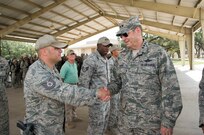 Gen. Robin Rand, commander of Air Education and Training Command, shakes hands with Tech. Sgt. Todd Kobee, security forces instructor, during a visit to the 343rd Training Squadron Oct. 29, 2014, at Joint Base San Antonio-Camp Bullis. Kobee is a security forces apprentice course instructor and teaches elements of career-field orientation, weapons training, ground combat skills, basic air base defense tactics, law enforcement and additional survival tactics training to meet the needs of today's security forces Airmen. (U.S. Air Force photo by Johnny Saldivar) 