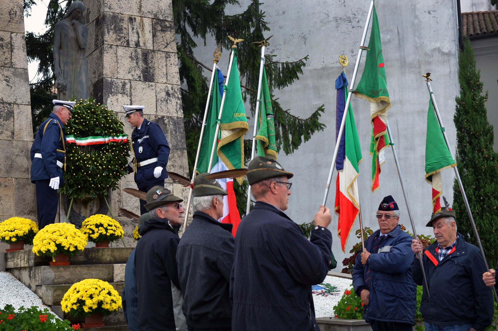 Members of Aviano’s Alpini Group hold the Italian flags as a wreath is laid, Nov. 4, 2014, in Aviano, Italy. The Italian holiday commemorates the end of World War I and those who gave the ultimate sacrifice during the war. During the memorial, three wreaths were laid in honor of the "Pagliano e Gori" Italian Air Force, the Aviano municipality and the 31st Fighter Wing. (U.S. Air Force photo/Senior Airman Abbey Whittaker)