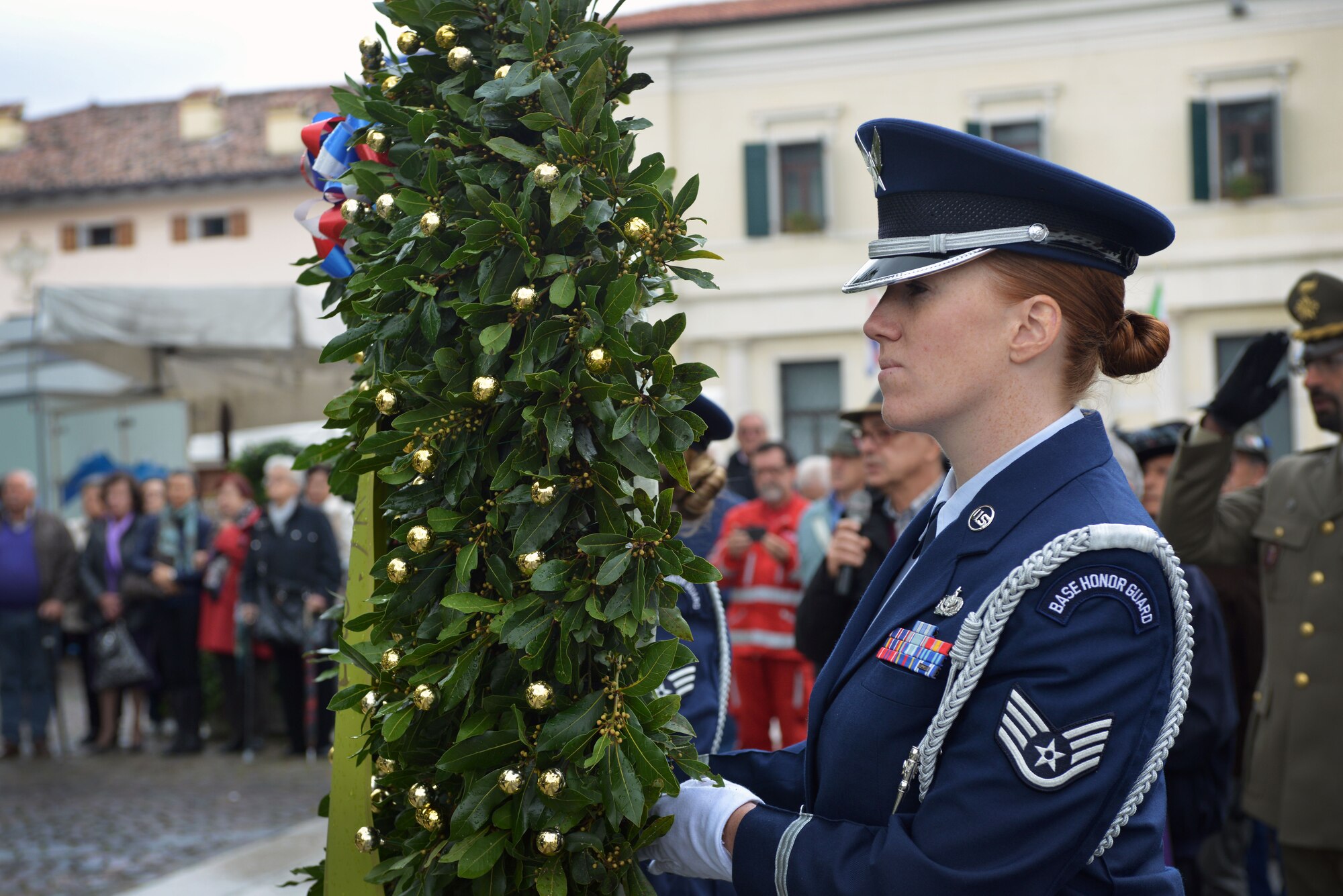 Staff Sgt. Elizabeth DeHaven, Aviano Base Honor Guard member, holds a wreath during the Italian Armed Forces and Memorial Day, Nov. 4, 2014, in Aviano, Italy. The wreaths were laid at Aviano Square in remembrance for those who gave the ultimate sacrifice during World War I. During the memorial, three wreaths were laid in honor of the "Pagliano e Gori" Italian Air Force, the Aviano municipality and the 31st Fighter Wing. (U.S. Air Force photo/Senior Airman Abbey Whittaker)