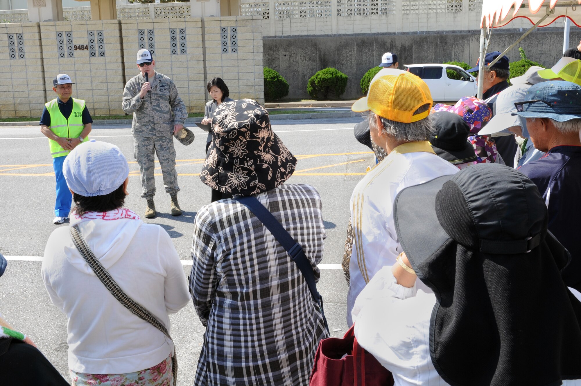 Masaharu Noguni, Chatan Town mayor and U.S. Air Force Brig. Gen. James Hecker, 18th Wing commander, speak to tsunami evacuation exercise participants on Kadena Air Base, Japan, Nov. 5, 2014. Chatan Town residents participated in a mock tsunami in order to practice evacuating from low elevation areas near the Sunabe seawall to higher ground on Kadena. The exercise was organized in support of an agreement signed by Noguni and Hecker in April that allows local Okinawans access to Kadena in the event of a natural disaster. (U.S. Air Force photo by Airman 1st Class Zade C. Vadnais/Released)