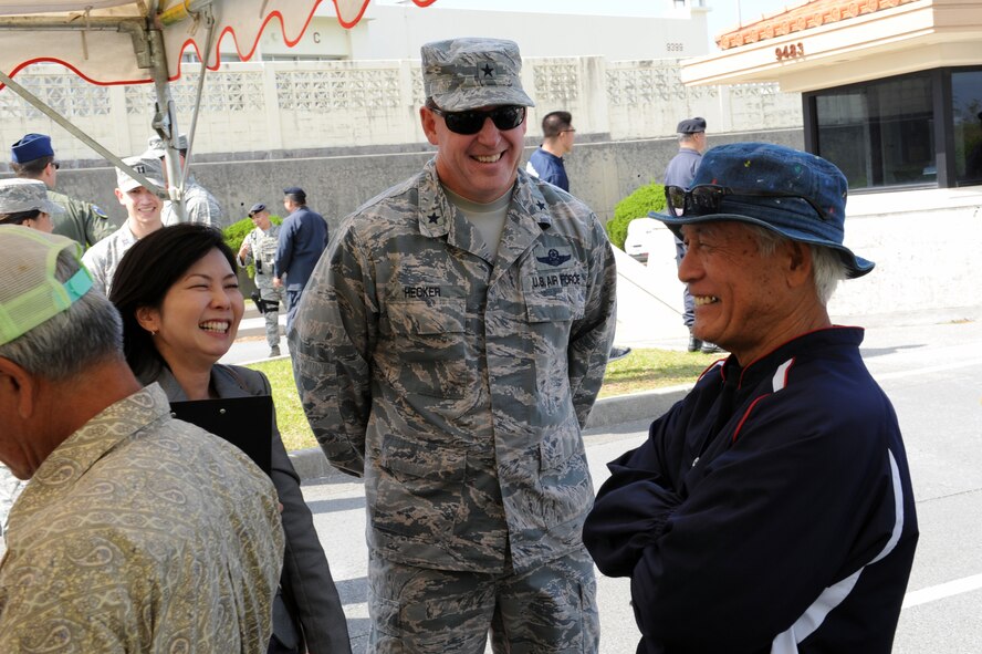 U.S. Air Force Brig. Gen. James Hecker, 18th Wing commander, talks with tsunami evacuation exercise participants on Kadena Air Base, Japan, Nov. 5, 2014. Chatan Town residents walked from Gate 1 to Gate 5 as part of an exercise which simulated evacuating Chatan Town residents to Kadena. The exercise was organized in support of an agreement made in April that opens Kadena's gates to the local population in the event of a natural disaster. (U.S. Air Force photo by Airman 1st Class Zade C. Vadnais/Released)