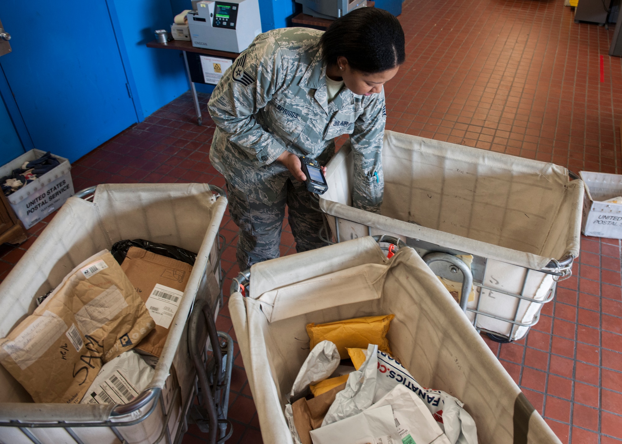 Staff Sgt. Ashley Spriggs, 8th Communications Squadron postal finance NCO in charge, sorts through packages at the post office at Kunsan Air Base, Republic of Korea. Airmen sending packages during the upcoming holidays can ensure Christmas delivery state-side by shipping no later than Dec. 3 at standard delivery rate, Dec. 10 at priority rate and Dec. 17 at express rate. (U.S. Air Force photo by Senior Airman Katrina Heikkinen/Released)