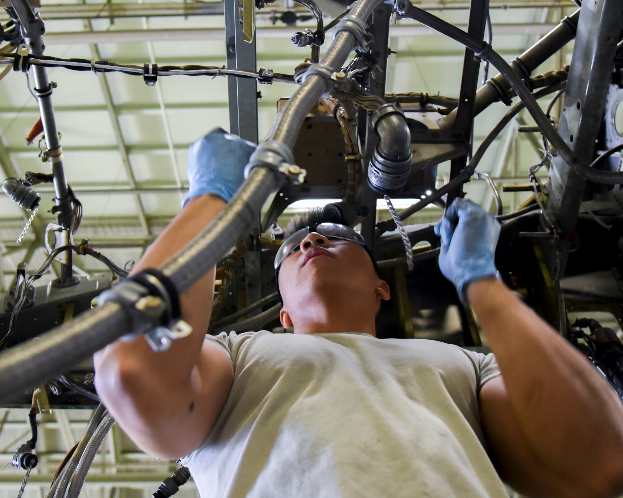 Airman 1st Class Bryan Sabangan, 374th Maintenance Squadron aerospace propulsion flight journeyman, helps remove components from the quick engine change kit of a C-130 T56 engine at Yokota Air Base, Japan, Oct. 29, 2014. The propulsion flight Airmen fix C-130 engines for both Yokota and Kadena Air Base. (U.S. Air Force photo by Senior Airman Michael Washburn/Released)