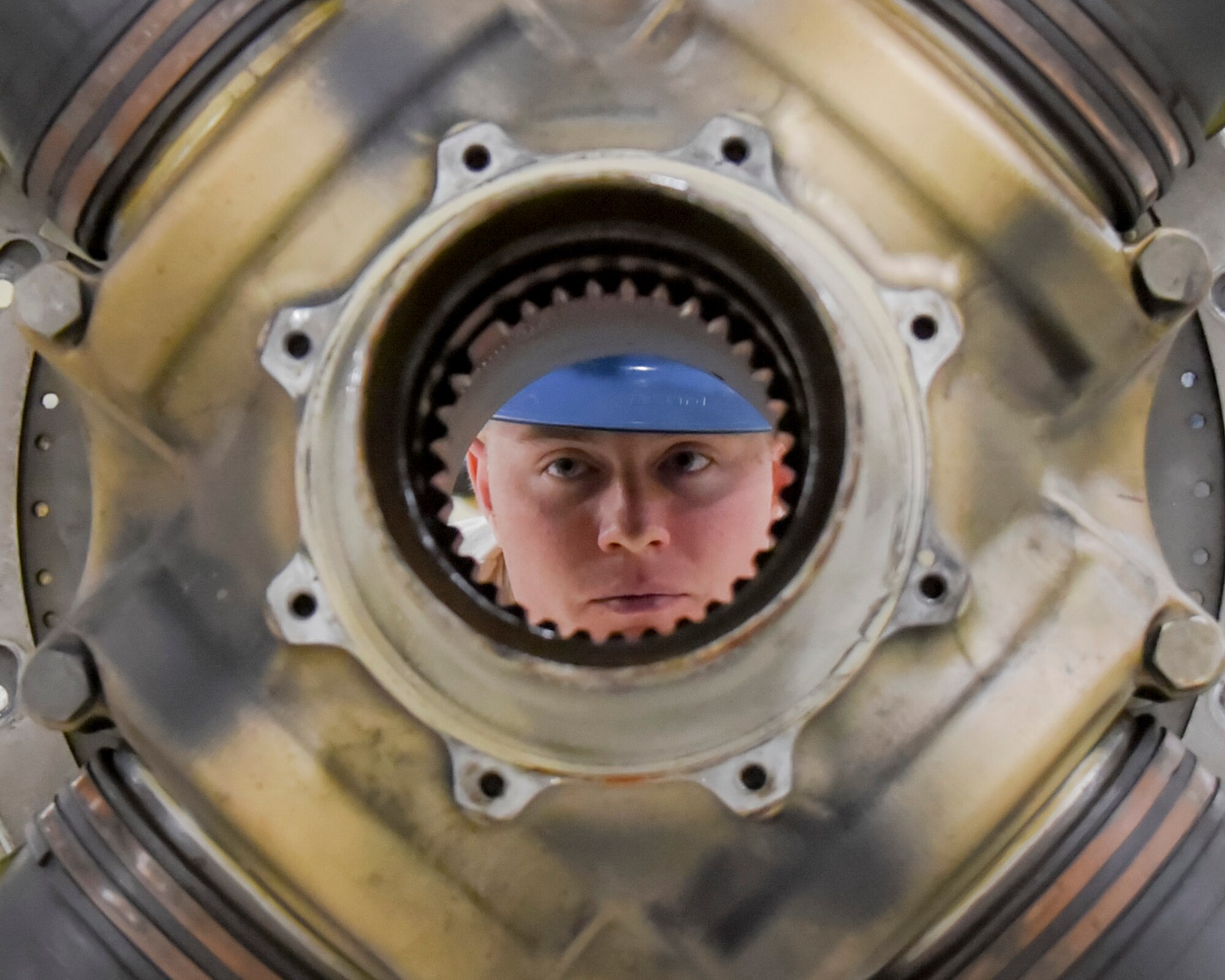 Senior Airman Colton Windsor, 374th Maintenance Squadron aerospace propulsion flight journeyman, inspects a disassembled C-130 propeller system after finishing a complete prop teardown at Yokota Air Base, Japan, Oct. 29, 2014. This particular prop could not be properly balanced which caused a vibration when running. (U.S. Air Force photo by Senior Airman Michael Washburn/Released)