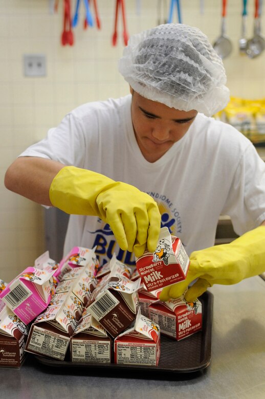 Ty Murdock, 11th grade Kadena High School student, stocks the cafeteria with milk for the students’ lunch on Kadena Air Base, Japan, Nov. 4, 2014. Murdock will be competing in the 30 meter dash in the Kadena Special Olympics and this is his 12th consecutive year participating. (U.S. Air Force photo by Staff Sgt. Marcus Morris)