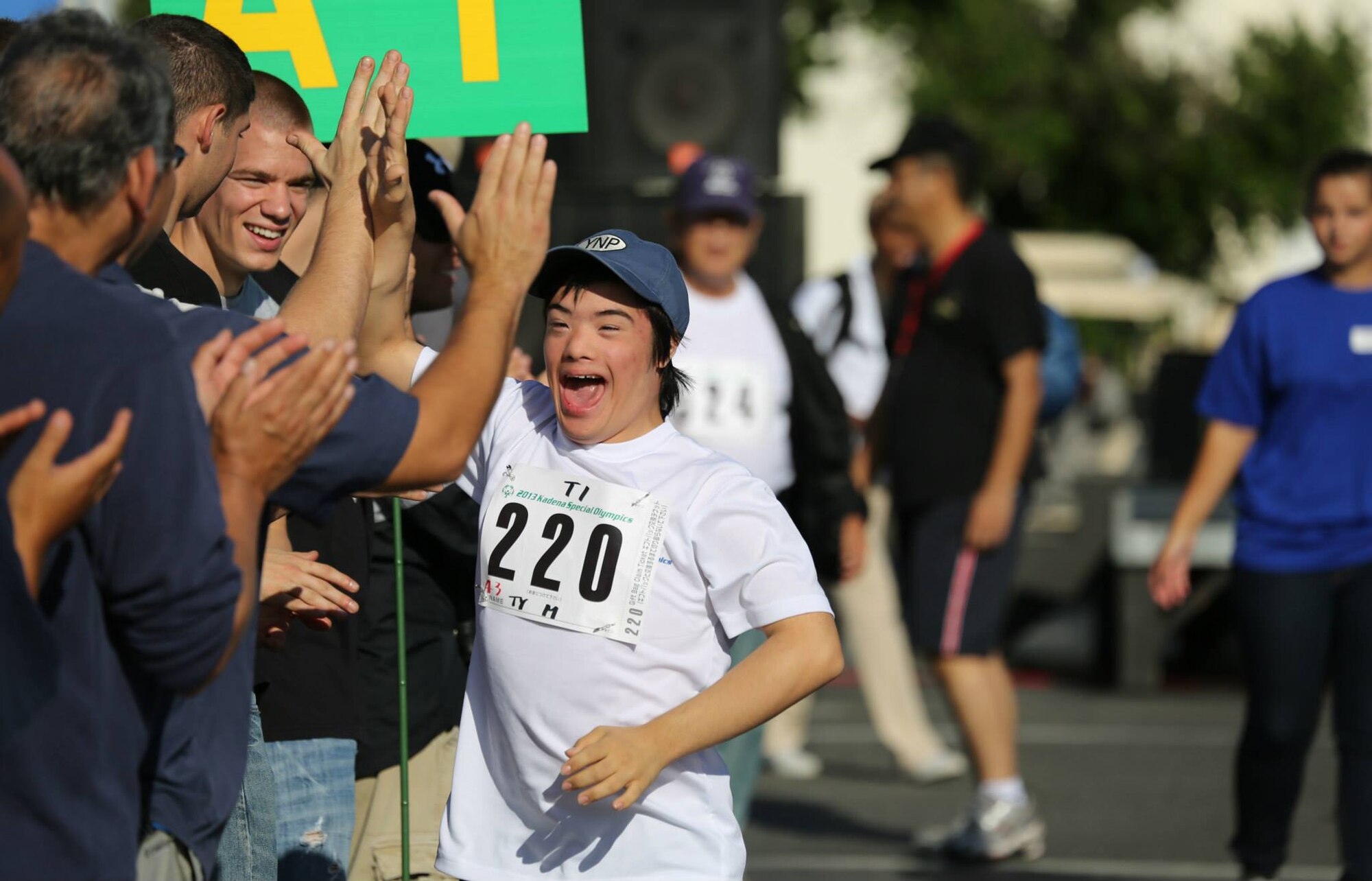 Ty Murdock, Kadena 10th grade High School student, runs a 30-meter dash during the Kadena Special Olympics on Kadena Air Base, Japan, Nov. 2, 2013. Murdock will be competing again this year in the KSO, making this his 12th consecutive year. He enjoys the applause and cheering from the crowd when he races and the competition. (Courtesy photo by Gordon Murdock)
