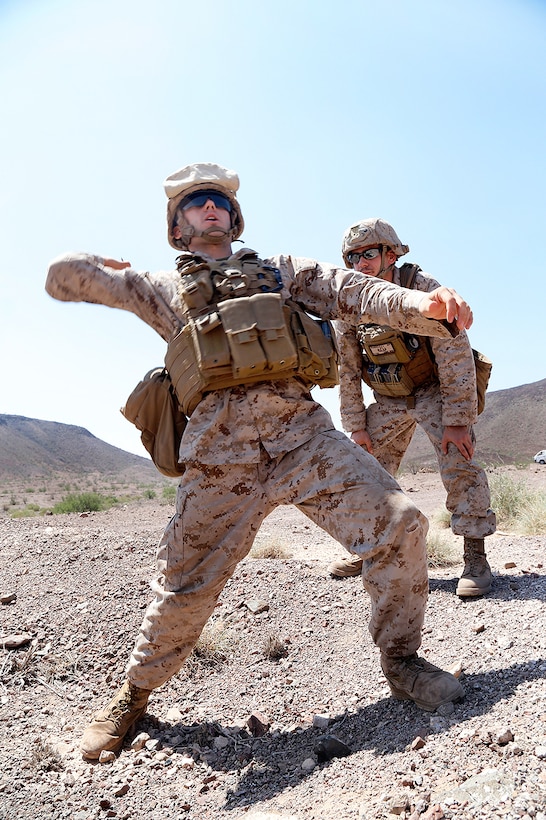 U.S. Marine Corps Sgt. Robert J. Scarpello, right, observes a Marine throwing an M69 practice grenade during sustainment training at D’Arta Plage, Djibouti, Nov. 1, 2014. Scarpello is an explosive ordnance disposal technician assigned to Combat Logistics Battalion 11, 11th Marine Expeditionary Unit.