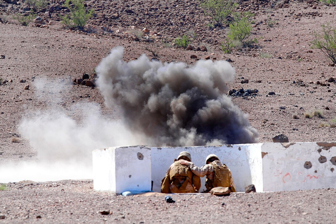 U.S. Marines take cover after throwing an M67 fragmentation grenade during sustainment training at D’Arta Plage, Djibouti, Nov. 1, 2014.