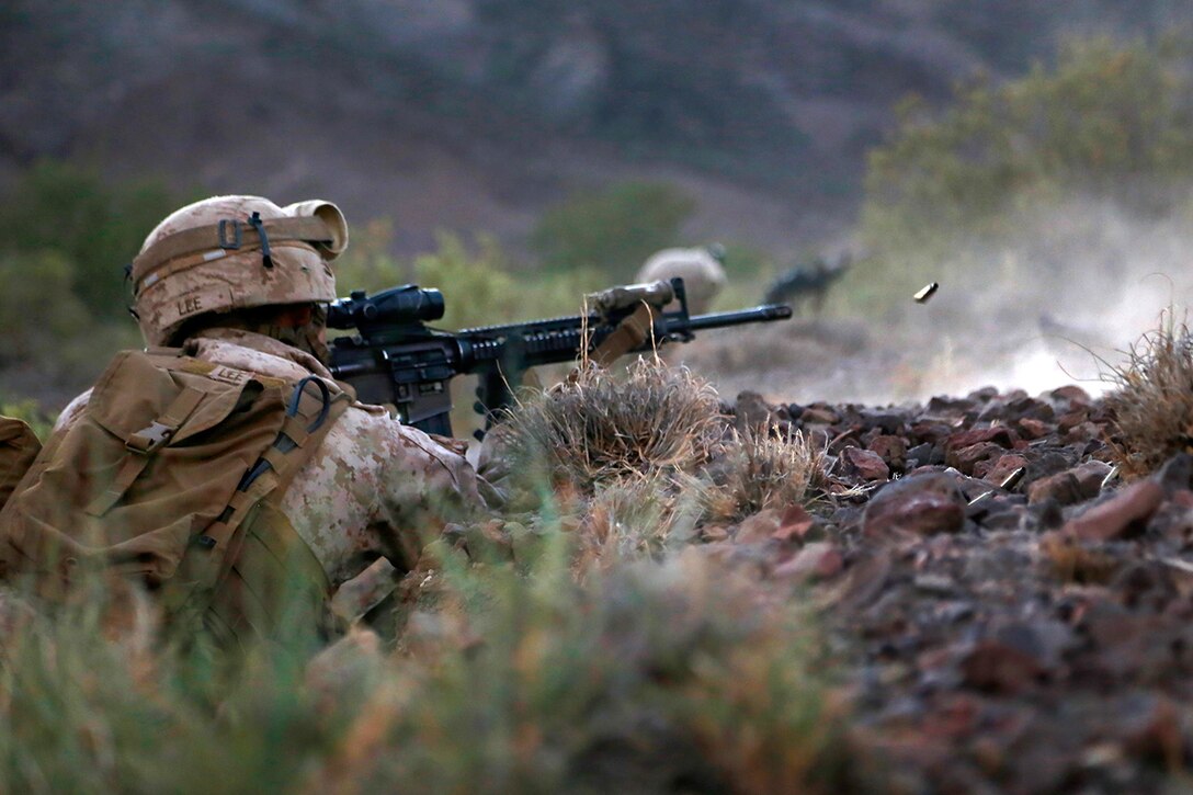 U.S. Marines take cover near their objective during a live-fire and movement exercise at D’Arta Plage, Djibouti, Nov. 3, 2014.