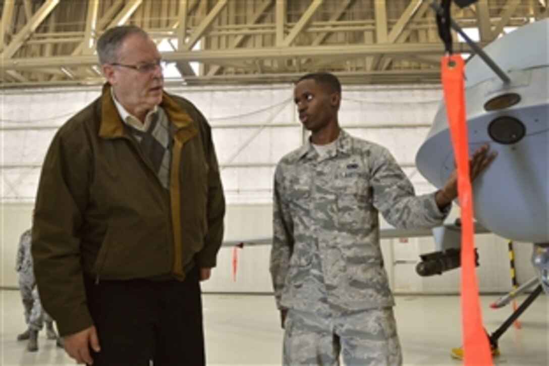 Airman Adryen Reed briefs Deputy Defense Secretary Bob Work on a remotely piloted aircraft during Work's visit to Creech Air Force Base near Las Vegas, Nov. 4, 2014.