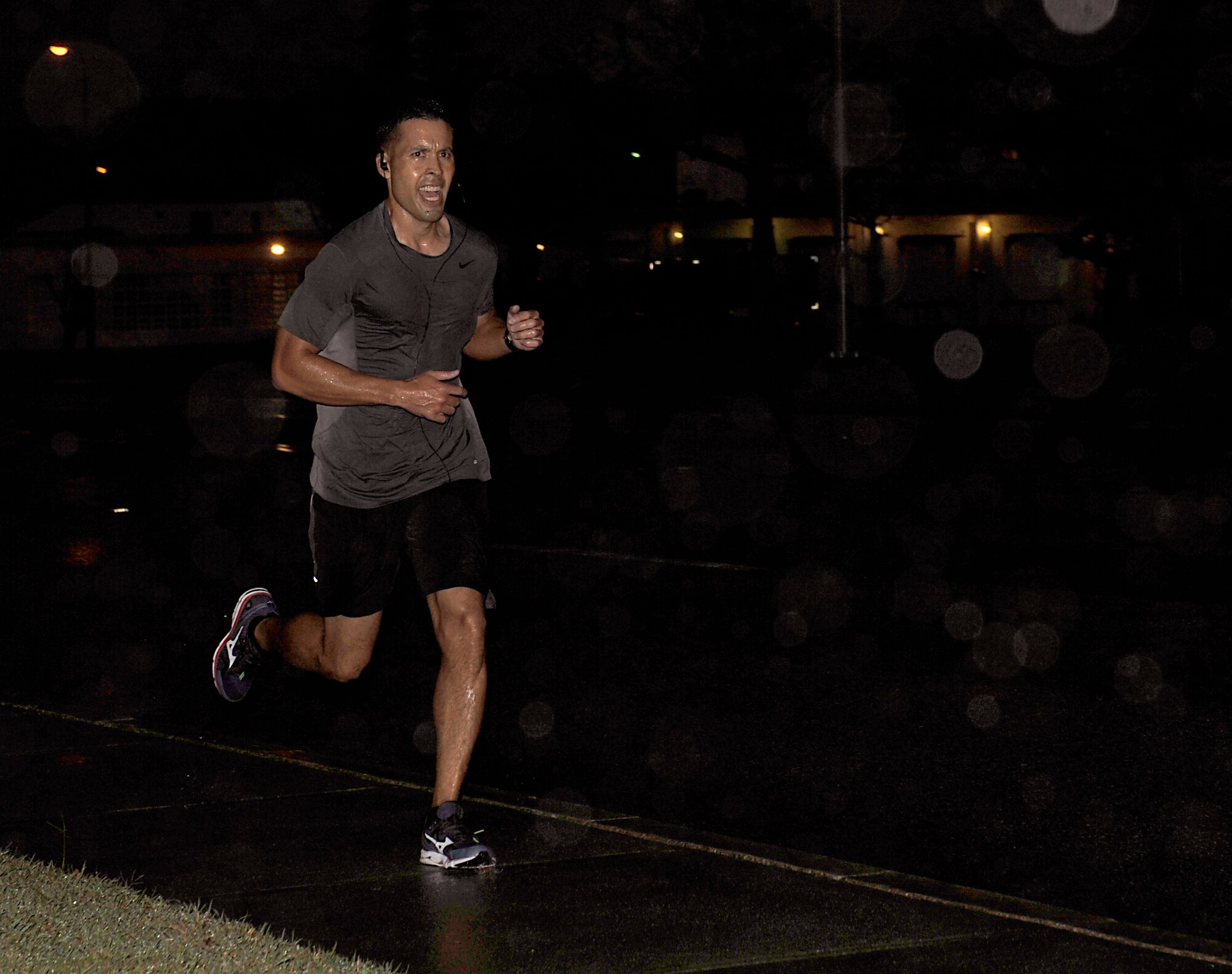 U.S. Air Force Senior Master Sgt. James Clark, 718th Civil Engineer Squadron superintendent, crosses the finish line of the KSO 5k fun run in first place with 18 minutes, 10 seconds on Kadena Air Base, Japan, Oct. 31, 2014. The 5k fun run is an annual event in tended to raise awareness of the Kadena Special Olympics. This year marks the 15th annual KSO, scheduled for Nov. 8. (U.S. Air Force photo by Naoto Anazawa)