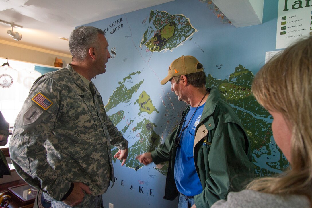 TANGIER, Va. – James “Ooker” Eskridge, mayor of Tangier, points out some areas of concern to Col. Paul Olsen, Norfolk District commander, on a map at the Tangier Island history museum here November 3, 2014. The district is working on a jetty project for the island as well as dredging the island’s navigation channel. 