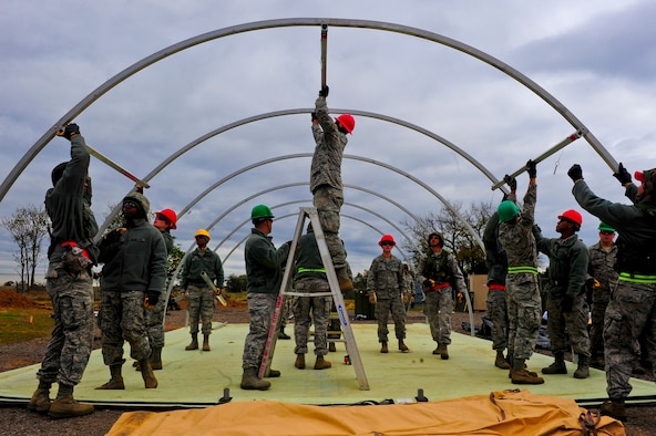 Airmen with the 567th RED HORSE out of Seymour Johnson Air Force Base, N.C., construct a tent during a field training exercise Nov. 3, 2014, at Fort Smith, Ark. The exercise provides upgrade training and preparation for an upcoming operation in support of Beyond the Horizon. Beyond the Horizon, conducted annually, is part of U.S. Army South and U.S. Southern Command’s humanitarian and civic assistance program, which works closely with host-nation forces and civilian organizations to provide medical, dental, and engineering support. (U.S. Air Force photo/Airman 1st Class Brittain Crolley)