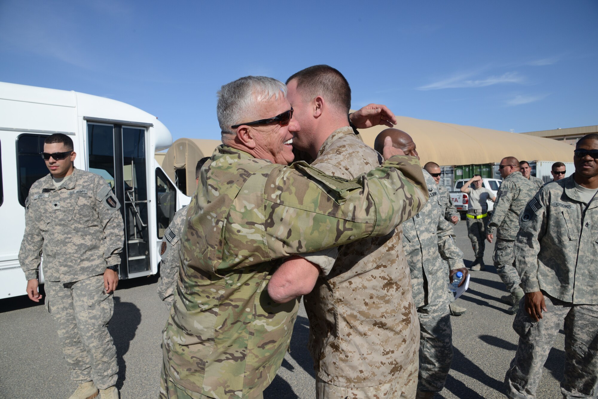A Wounded Warrior hugs an Operation Proper Exit volunteer during a  return here from Afghanistan on Nov. 2, 2014. Operation Proper Exit, part of the Troops First Foundation, provides the opportunity for wounded warriors to return to the battle space, share their experiences – both good and bad – and most importantly, leave the theater on their own terms. (U.S. Air Force photo by Tech. Sgt. Jared Marquis)