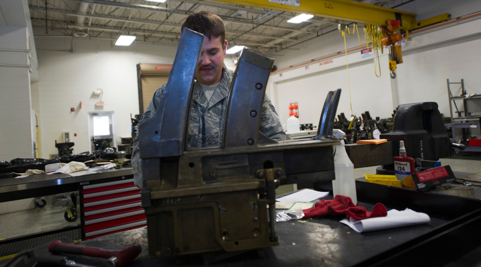 Senior Airman Jonathan Ammons, 1st Special Operations Equipment Maintenance Squadron armament journeyman, cleans and inspects a 40 mm automatic loader at the armament shop on Hurlburt Field, Fla., Nov. 4, 2014. Automatic loaders are cleaned and inspected weekly. (U.S. Air Force photo/Senior Airman Krystal M. Garrett)