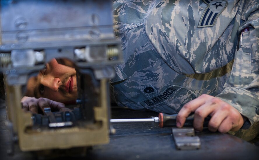 Senior Airman Jonathan Ammons, 1st Special Operations Equipment Maintenance Squadron armament journeyman, cleans and inspects a 40 mm automatic loader at the armament shop on Hurlburt Field, Fla., Nov. 4, 2014. Armament Airmen maintain weapon equipment on and off the flightline. (U.S. Air Force photo/Senior Airman Krystal M. Garrett)