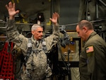 New York Air National Guard Master Sgt. Jerry Kurz, right, 102nd Rescue Squadron loadmaster, based at F.S. Gabreski Airport in Westhampton Beach, N.Y., assists Brig. Gen. William Hill, left, Mississippi Air National Guard chief of staff, with donning a safety harness on board an HC-130P King during exercise Southern Strike 15 (SS15) near the Combat Readiness Training Center (CRTC) in Gulfport, Miss., Oct. 30, 2014. 