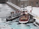 The lockcrew observing the tugboat Fredrick, which is surrounded by ice during the winter of 2014, in which 92 percent of the Great Lakes froze over.