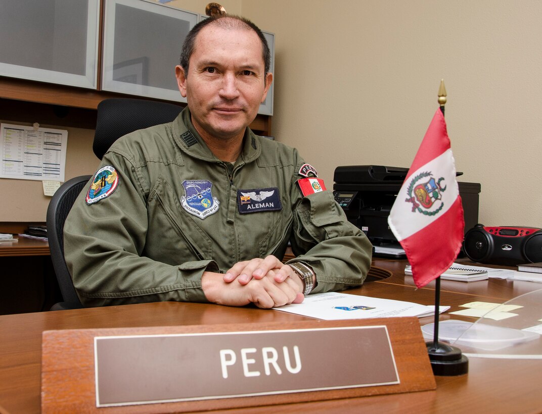 Col. Jaime Aleman smiles before preparing to execute his daily duties as a liaison officer Nov. 5, 2014, at Davis-Monthan Air Force Base, Ariz. Aleman, who has served eight months of his two year tour of duty as the Peruvian LNO, is using his time at Davis-Monthan AFB to build partner capacity between the United States and Peru, while improving his English language skills. Aleman is the Air Forces Southern Peruvian LNO. (U.S. Air Force photo/Staff Sgt. Adam Grant)