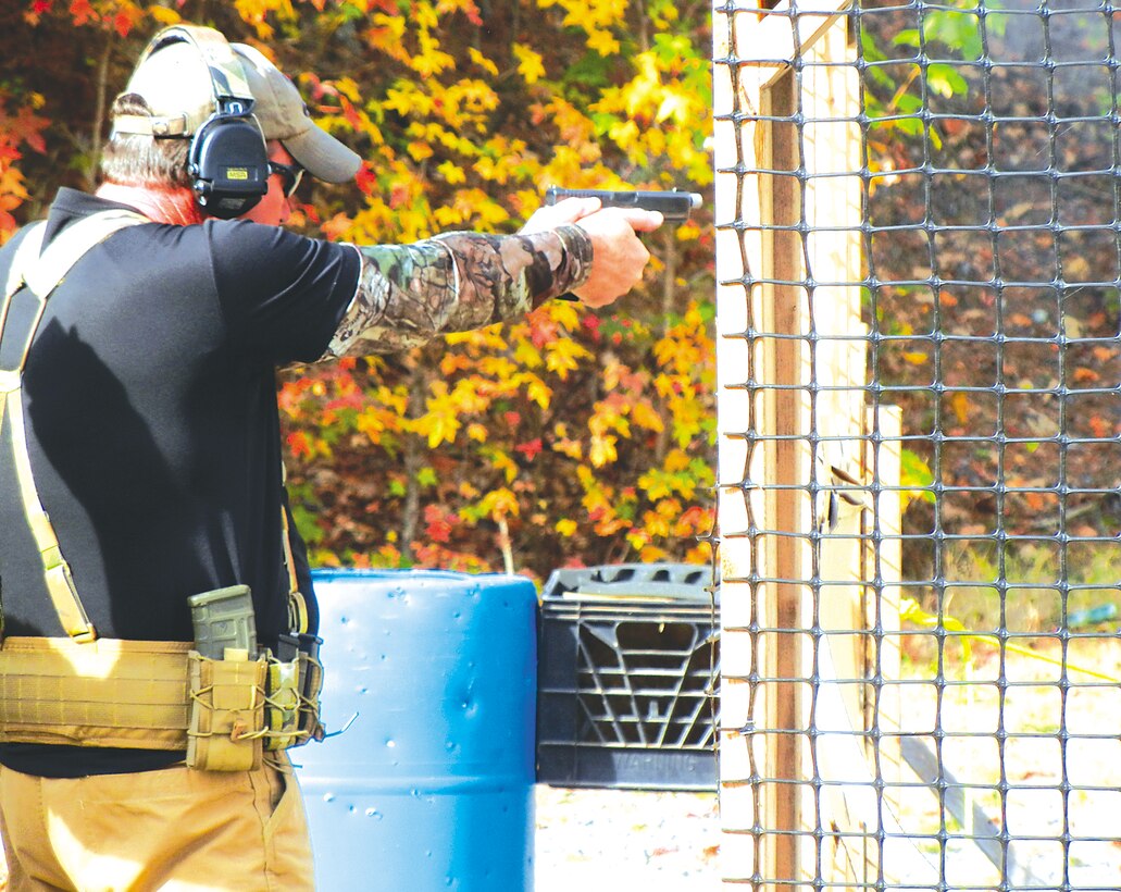 Tom Bullins, a civilian with Trigger Time Inc., takes aim with his pistol while competing in the 4th Annual Quantico Shooting Match aboard Marine Corps Base Quantico on Oct. 28.