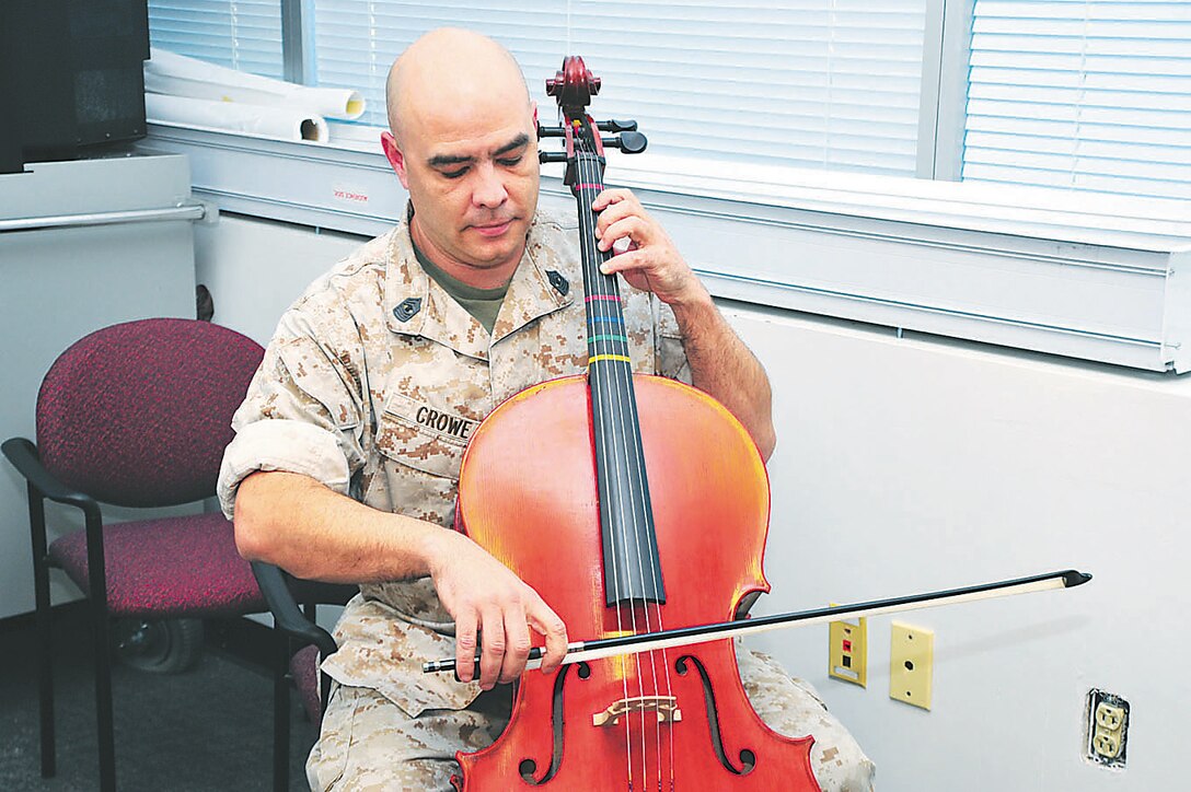 Gunnery Sgt. Norman Crowe practices cello in his office in the Marsh Building aboard Marine Corps Base Quantico in the evening. 