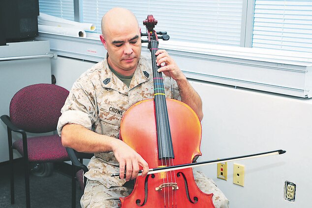 Gunnery Sgt. Norman Crowe practices cello in his office in the Marsh Building aboard Marine Corps Base Quantico in the evening. 