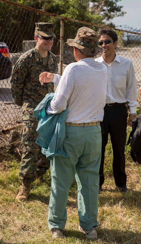 Maj. Andrew Merz, from Lansing, Michigan, talks to a Kin Town resident after the tsunami evacuation drill Nov. 5 at Camp Hansen. This was the first exercise since the local disaster response agreement was signed by Marine Corps and Kin Town officials in September. The drills improved the communication between Camp Hansen, Kin Town Officers, Ishi Kawa police and the local community leaders responsible for disaster response, according to Masaru Nago, from Kin Town. Merz is the operations officer for Camp Hansen.