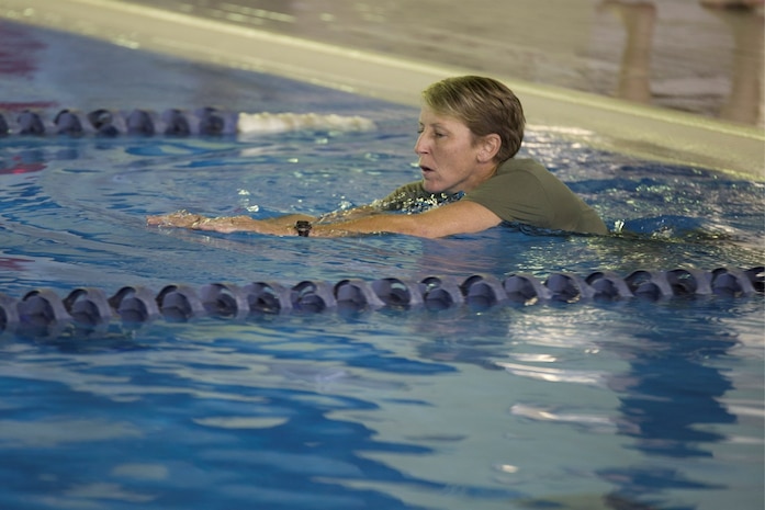 Gunnery Sgt. Kelly Anderson, assistant operations chief with the Provost Marshal’s Office, participates in the Marine Corps Birthday swim at the indoor pool in the Iron Works gym aboard Marine Corps Air Station Iwakuni, Japan, Nov. 3, 2014. The squadron finished the, roughly, 149 mile swim in one day.