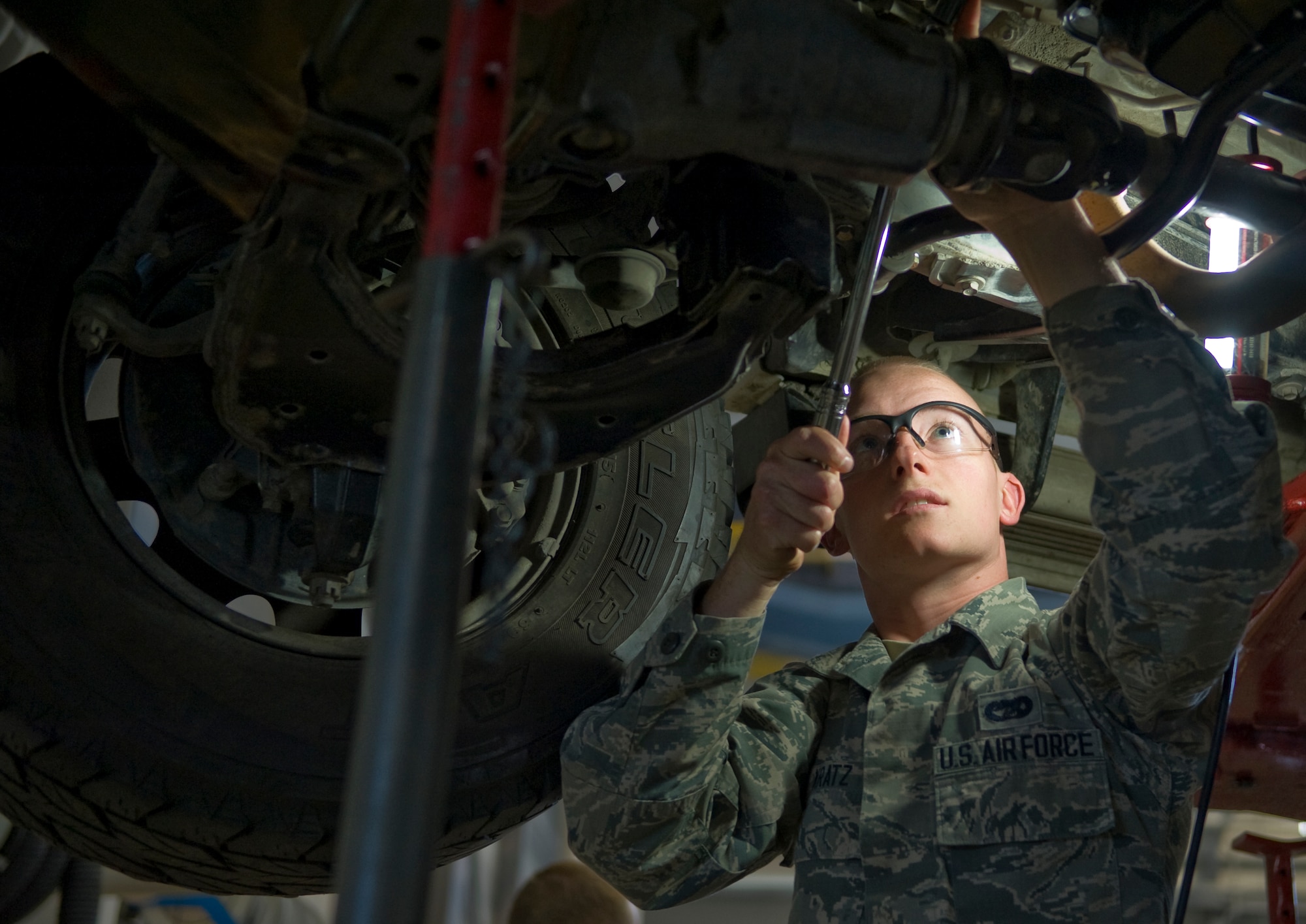 U.S. Air Force Airman 1st Class Bradley Kratz, 35th Logistics Readiness Squadron vehicle mechanic, works on the underside of a vehicle at Misawa Air Base, Japan, Oct. 31, 2014. Kratz inspects, troubleshoots and repairs vehicles used in direct support of the Air Force operations. Airman 1st Class Bradley Kratz was selected as the 35 LRS Wild Weasel of the Week. (U.S. Air Force photo by Airman 1st Class Jordyn Rucker/Released)