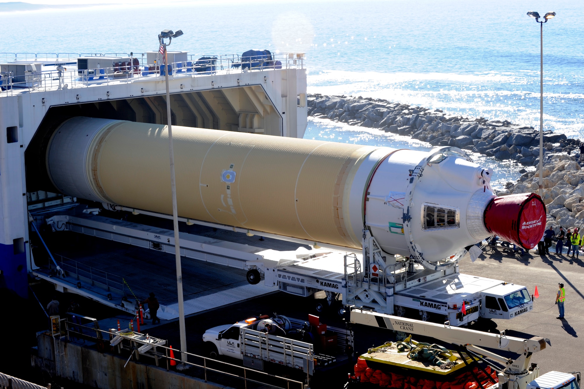 A cargo ship, the Delta Mariner, unloads a booster for the United Launch Alliance Delta IV rocket, Nov. 5, 2014, Vandenberg Air Force Base, Calif. Various Air Force personnel were on site at Vandenberg’s only dock, which exists solely to accommodate the Mariner’s rocket deliveries. (U.S. Air Force photo by Senior Airman Shane M. Phipps/Released)
