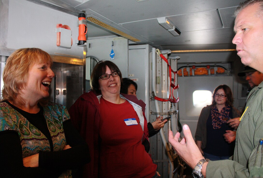 TRAVIS AIR FORCE BASE, Calif. -- Spouses of 349th Air Mobility Wing Reservists chat with Col. Patrick Williams abaord a KC-10 Extender aircraft as part of the wing's Focus on the Family event Oct. 25, 2014, at Travis Air Force Base, Calif. The event included an orientation flight for spouses on either the KC-10, C-5, or C-17 aircraft, briefings and informative sessions on the benefits of being an Air Force Reserve spouse and a barbecue lunch to bring together all as part of the "349th Family". Another Focus on the Family event is scheduled to be held during the November 2014 A Flight Unit Training Assembly weekend. Williams is the wing's vice commander (Courtesy photo/Lindsey M. Collier)