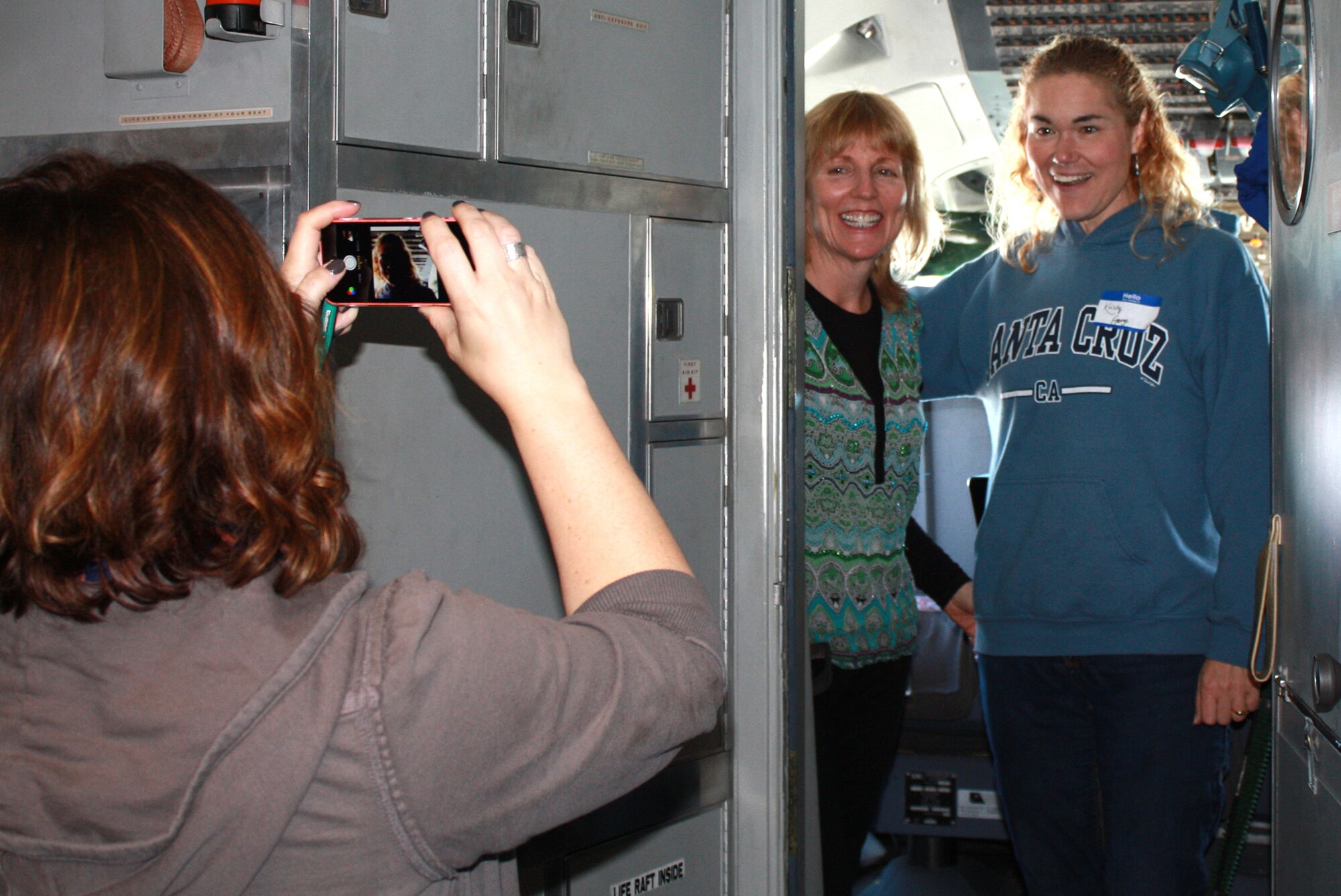 Spouses of 349th Air Mobiltiy Wing Reservists capture the moment of flying aboard a KC-10 Extender during the wing's Focus on the Family event Oct. 25, 2014, at Travis Air Force Base, Calif. The event included an orientation flight for spouses on either the KC-10, C-5, or C-17 aircraft, briefings and informative sessions on the benefits of being an Air Force Reserve spouse and a barbecue lunch to bring together all as part of the "349th Family". Another Focus on the Family event is scheduled to be held during the November 2014 A Flight Unit Training Assembly weekend. (Courtesy photo/Lindsey M. Collier) 