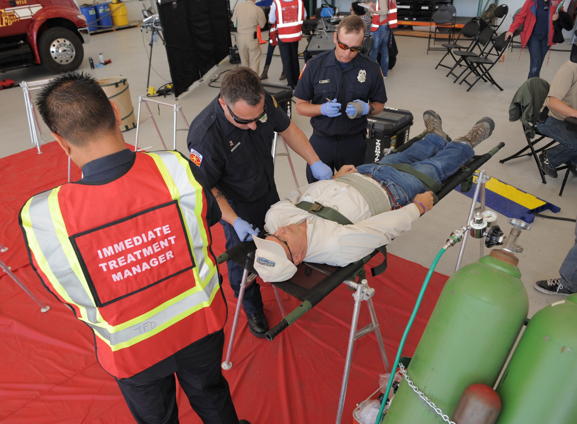 Paramedics from the Pima County Rural/Metro Fire Department treat a simulated victim during a Natural Disaster Medical System exercise at Davis-Monthan Air Force Base, Ariz., Nov. 5, 2014. D-M would be the primary patient reception site in southern Arizona in the event of a real-world natural disaster response. (U.S. Air Force photo by Airman 1st Class Chris Drzazgowski/Released)
