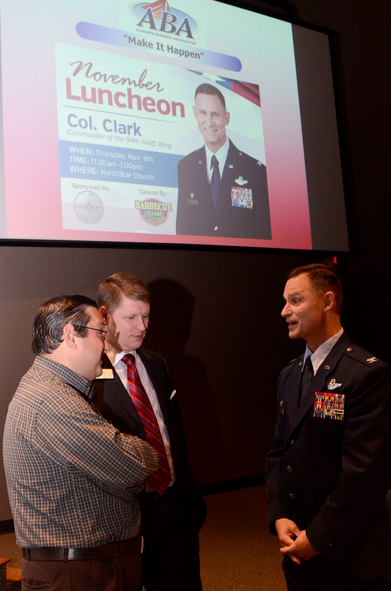Col. Brett Clark, 94th Airlift Wing commander, visits with Mark Zangari, from Dollar Wise Cartridge, L.L.C and Acworth Business Association executive director of membership; and Andrew Windham, College Planning Institute vice president, while attending the Acworth Business Association monthly meeting in Acworth, Ga. Nov. 6, 2014. (U.S. Air Force photo by Don Peek/Released)